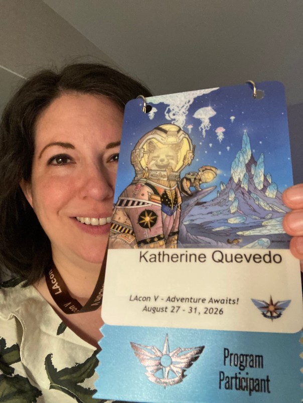 Selfie of author Katherine Quevedo holding her convention badge for LAcon V.