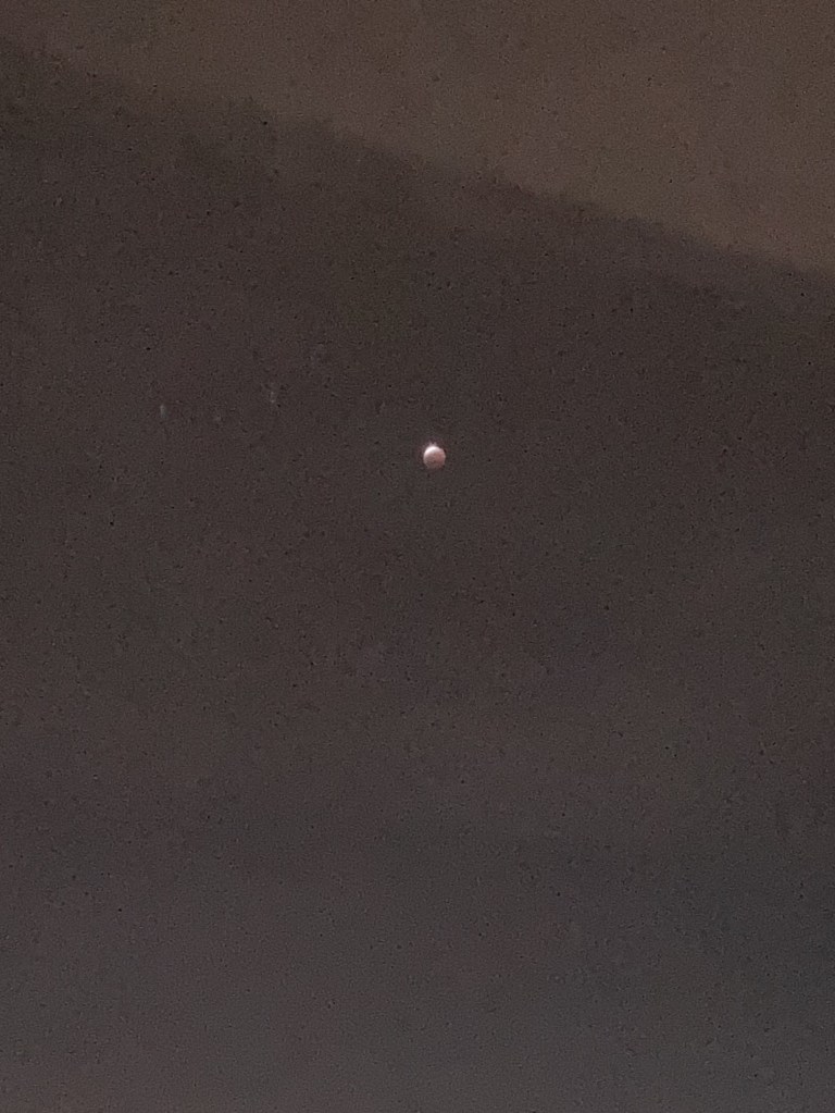 Partial lunar eclipse viewed from afar.